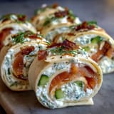 Creamy dill-infused cheese and smoked salmon wrapped in tortillas, sliced into elegant Smoked Salmon & Cucumber Cream Cheese Pinwheels.