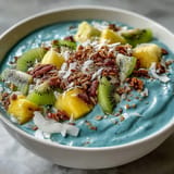 Creamy Blue Spirulina Smoothie Bowl swirled with blue, topped beautifully with fresh fruit.