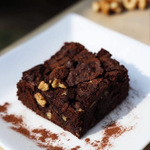 Warm brownies, ready to be cut and served, offering intense chocolate bliss.