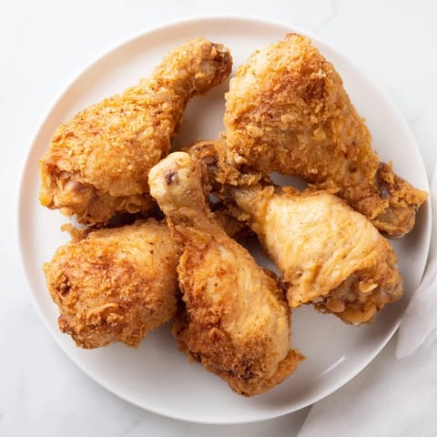 Close-up of freshly fried chicken, showing the delicious, crunchy crust on each piece.