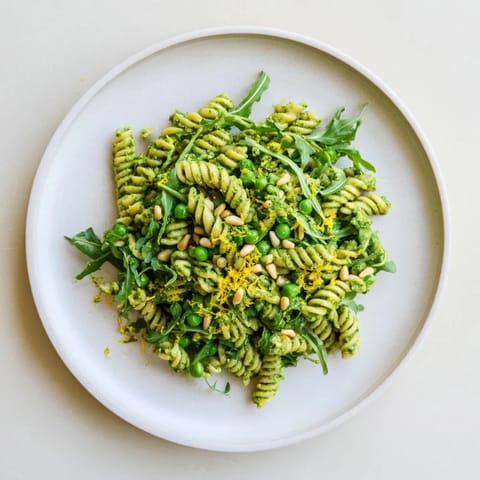 Served chilled for a spring picnic, this fresh pasta salad is garnished with crumbled feta and bright lemon zest.  
