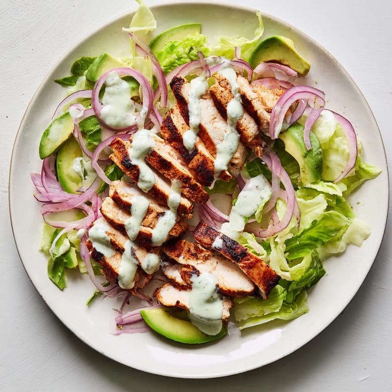 Grilled Smoky Chipotle Chicken Wrap served warm with tangy Greek yogurt sauce and diced tomatoes.