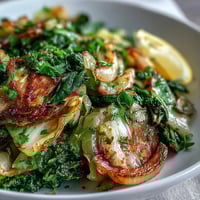 Sautéed Cabbage With Garlic and Mediterranean Spices sautéed until tender with caramelized edges and bright parsley garnish.