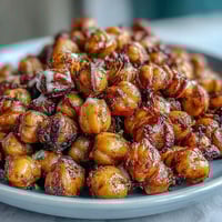 Vibrant roasted chickpea power bowl with crispy chickpeas, roasted sweet potatoes, and creamy tahini dressing. A nourishing vegan meal prep lunch idea.