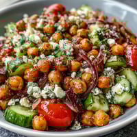 Cold Chickpea Salad with Lemon Herbs: a vibrant bowl of chickpeas, crisp cucumbers, and cherry tomatoes tossed in a bright lemon-herb dressing.